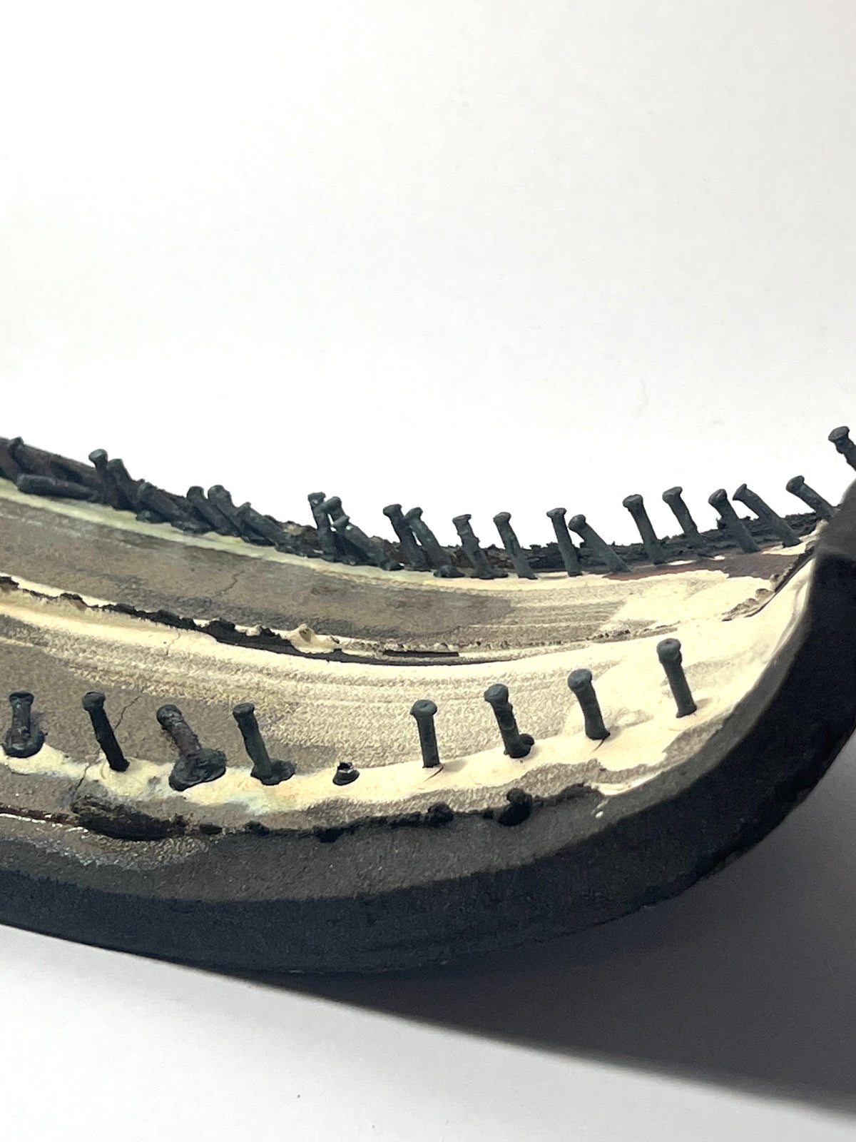 Small ceramic sculpture with nails by Andrew  Lawes