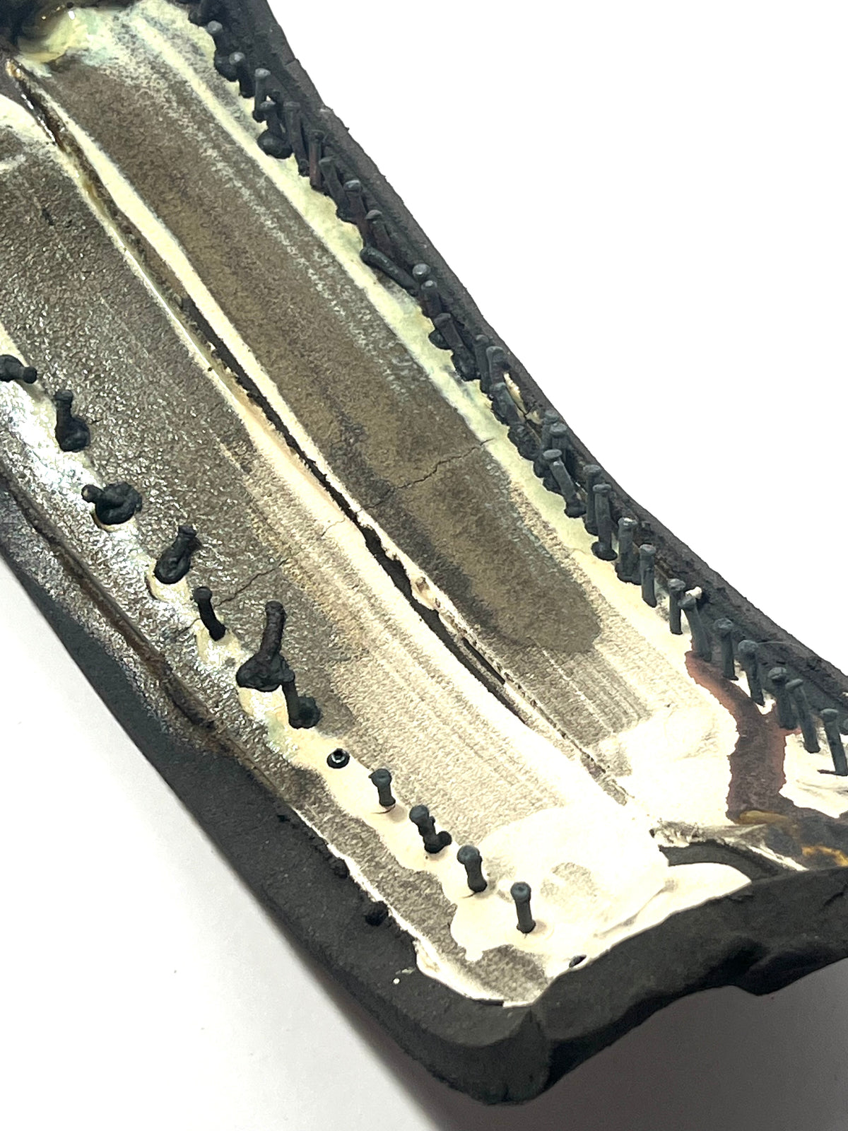 Small ceramic sculpture with nails by Andrew  Lawes