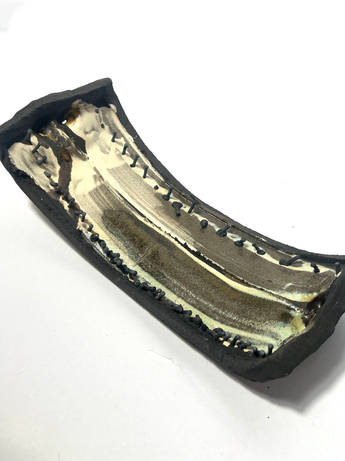 Small ceramic sculpture with nails by Andrew  Lawes